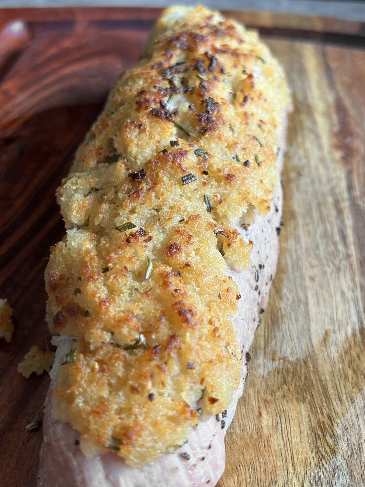 Low sodium horseradish pork tenderloin resting before being sliced and served.