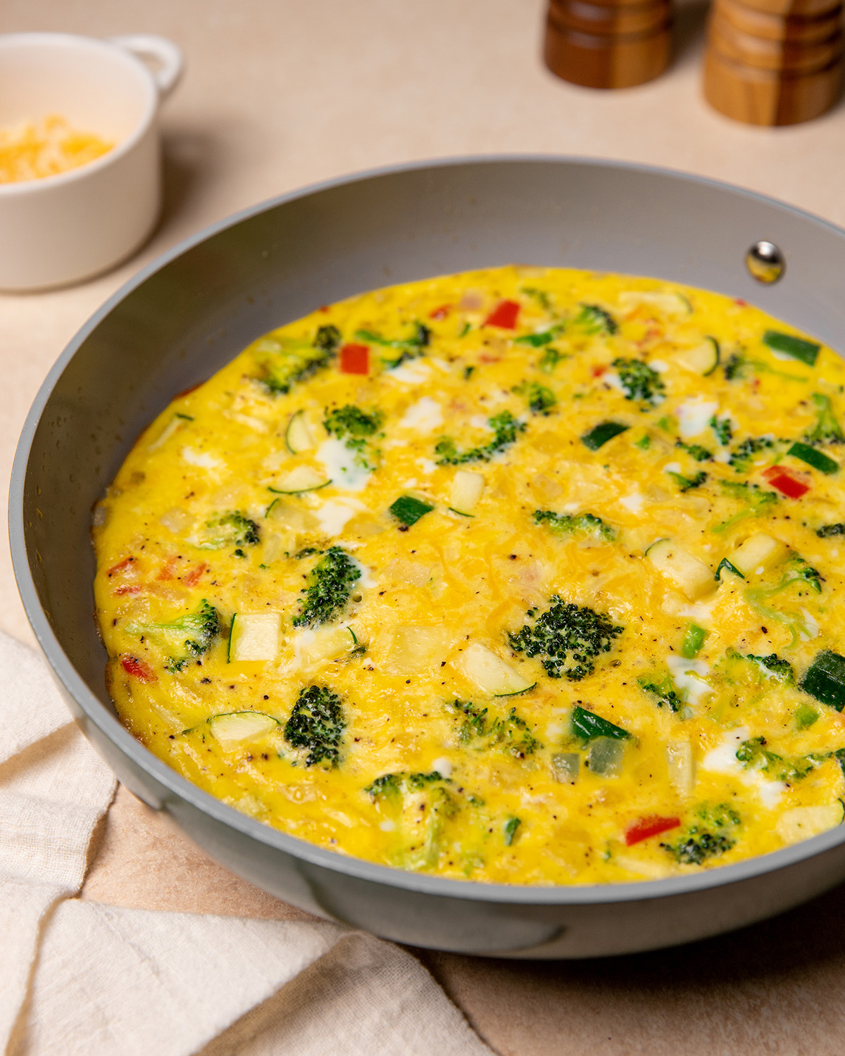 Egg and vegetable mixture in a pan for low sodium frittata recipe.