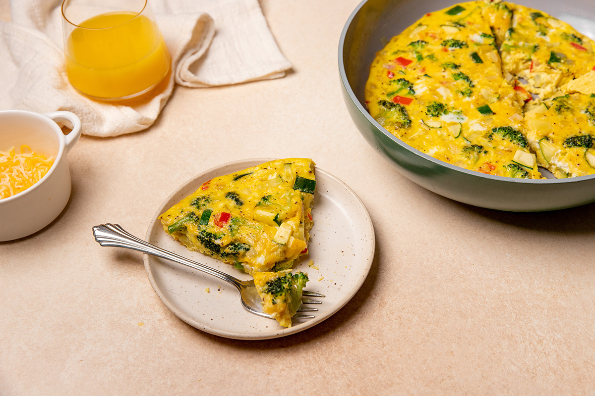 A serving of low sodium frittata on a white plate with a fork.