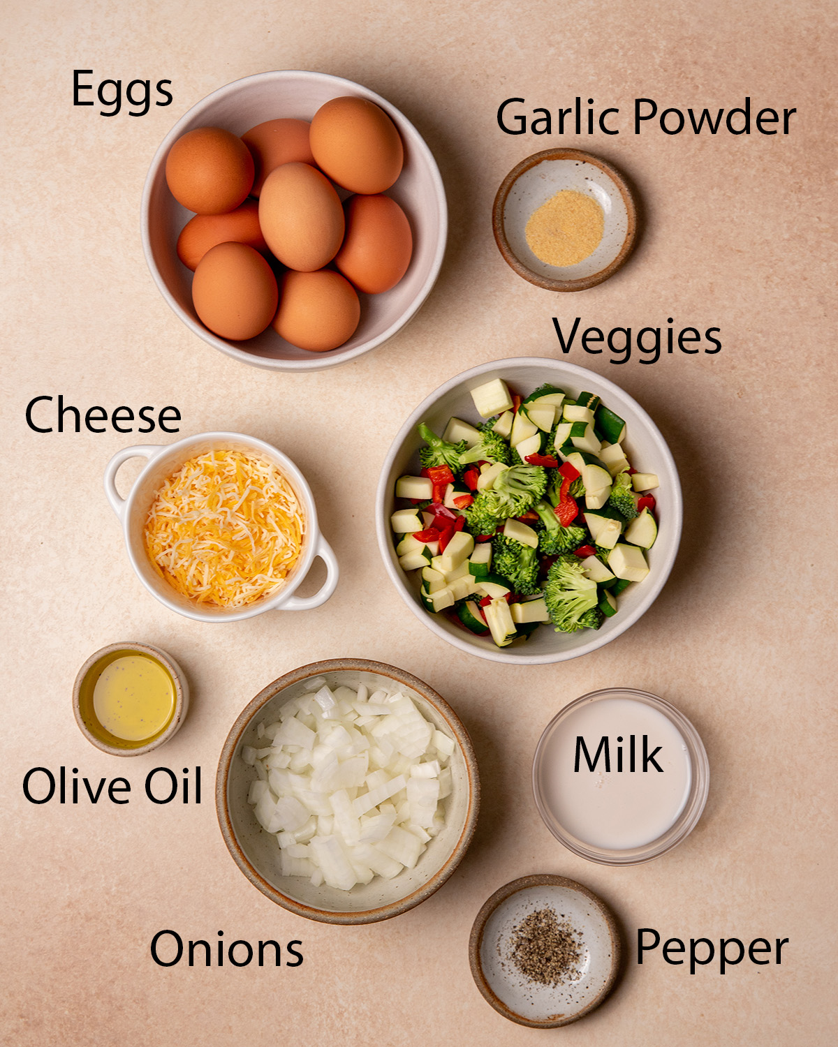 Ingredients for low sodium frittata over a cream colored surface.