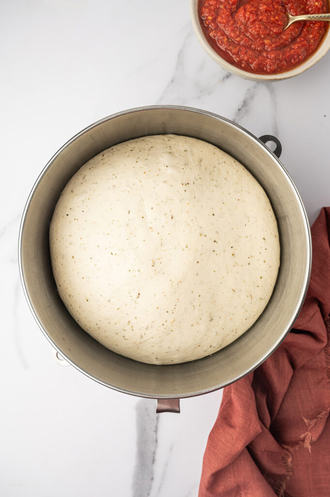 Rising pizza dough for low-sodium Margherita pizza recipe.