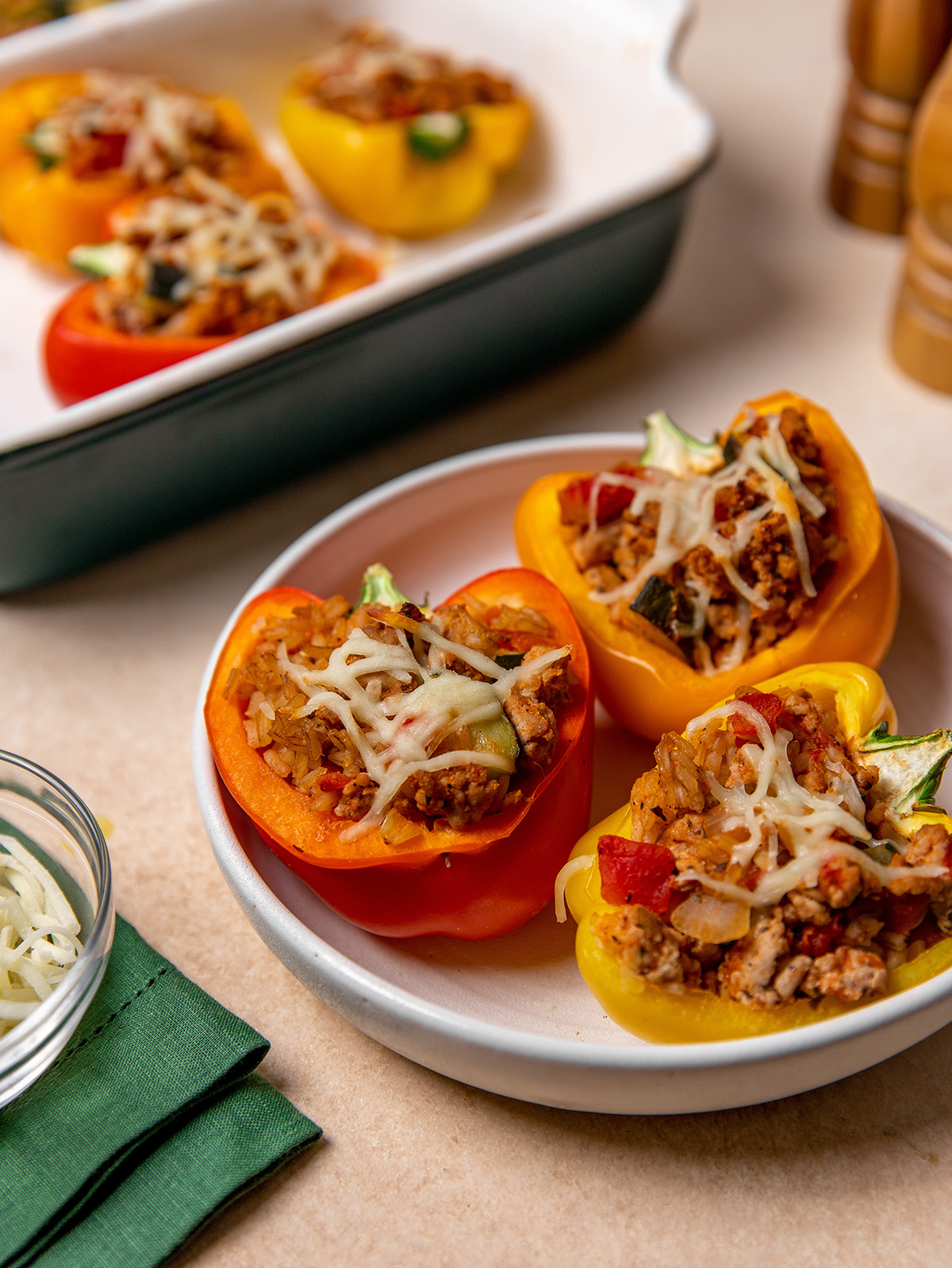 Three low-sodium stuffed peppers in a white bowl.