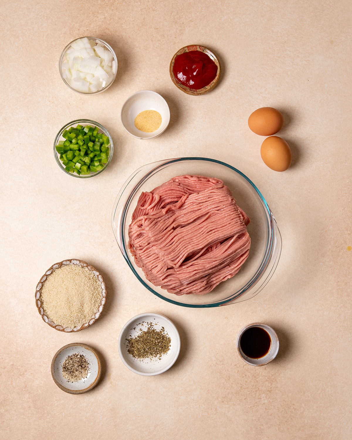 Ingredients for low-sodium turkey meatloaf over a cream colored surface.