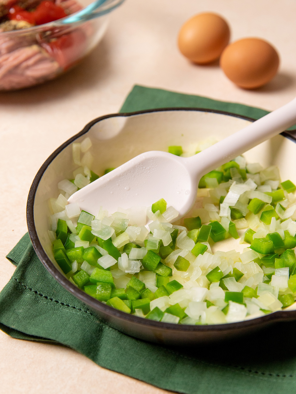 Chopped green bell pepper and onion in a bowl for low-sodium turkey meatloaf.