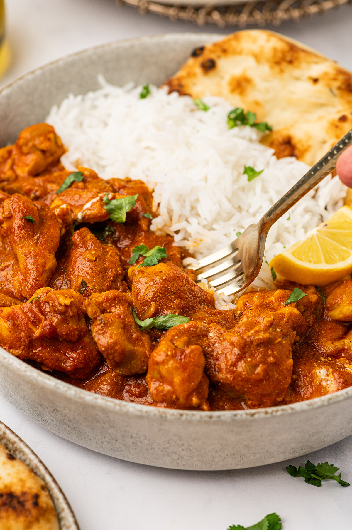 A close-up of low sodium butter chicken in a skillet, with the creamy sauce and tender chicken pieces ready to enjoy.