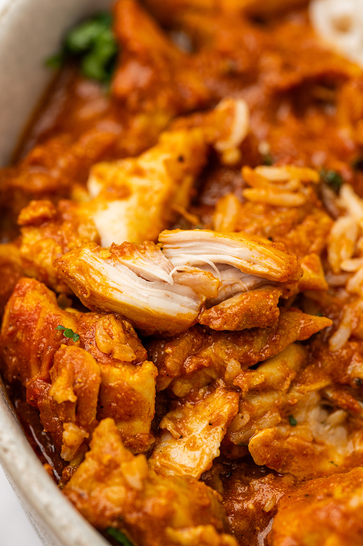 A close-up of shredded low sodium butter chicken in a creamy sauce.