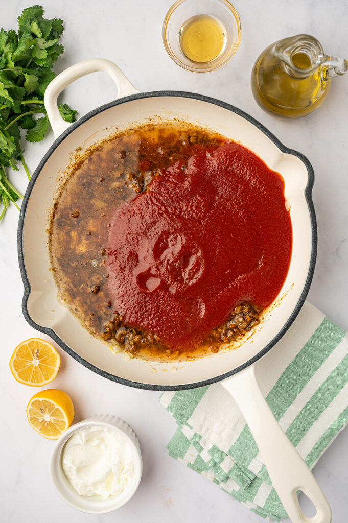 Sauce for low sodium butter chicken warming up in a skillet.