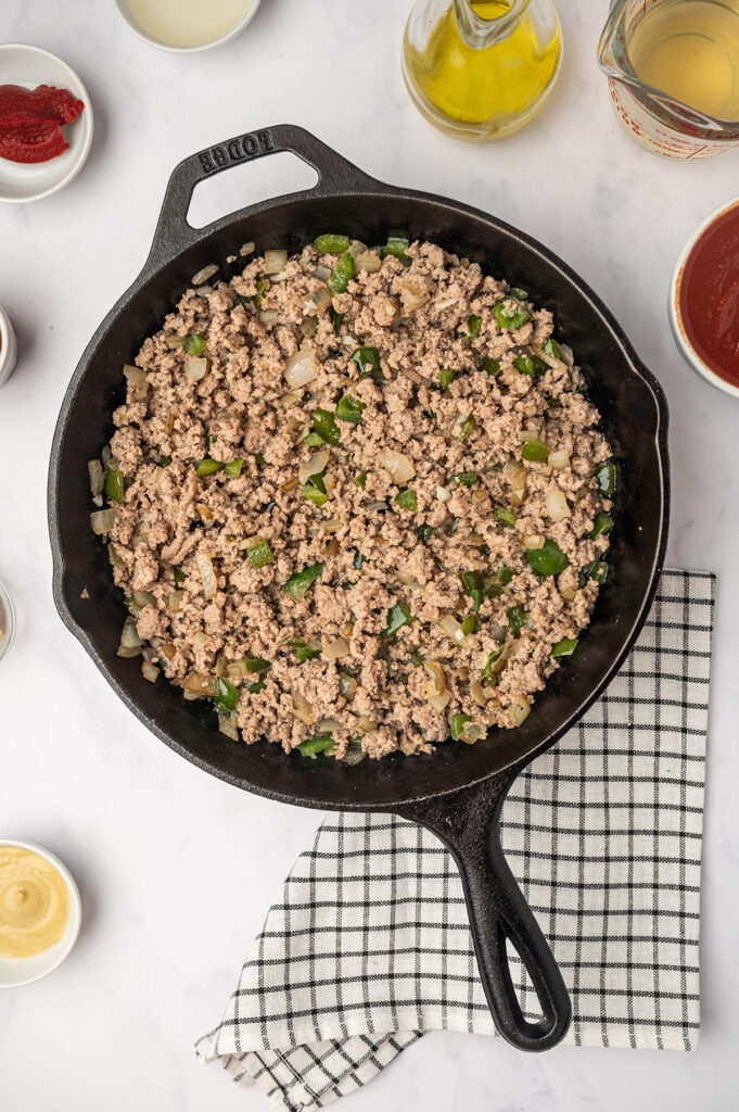 A skillet filled with savory low sodium sloppy joes mixture, featuring ground meat.