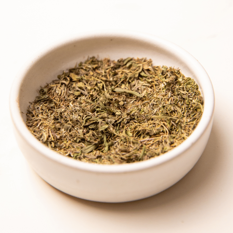 A white bowl of dried herbs.
