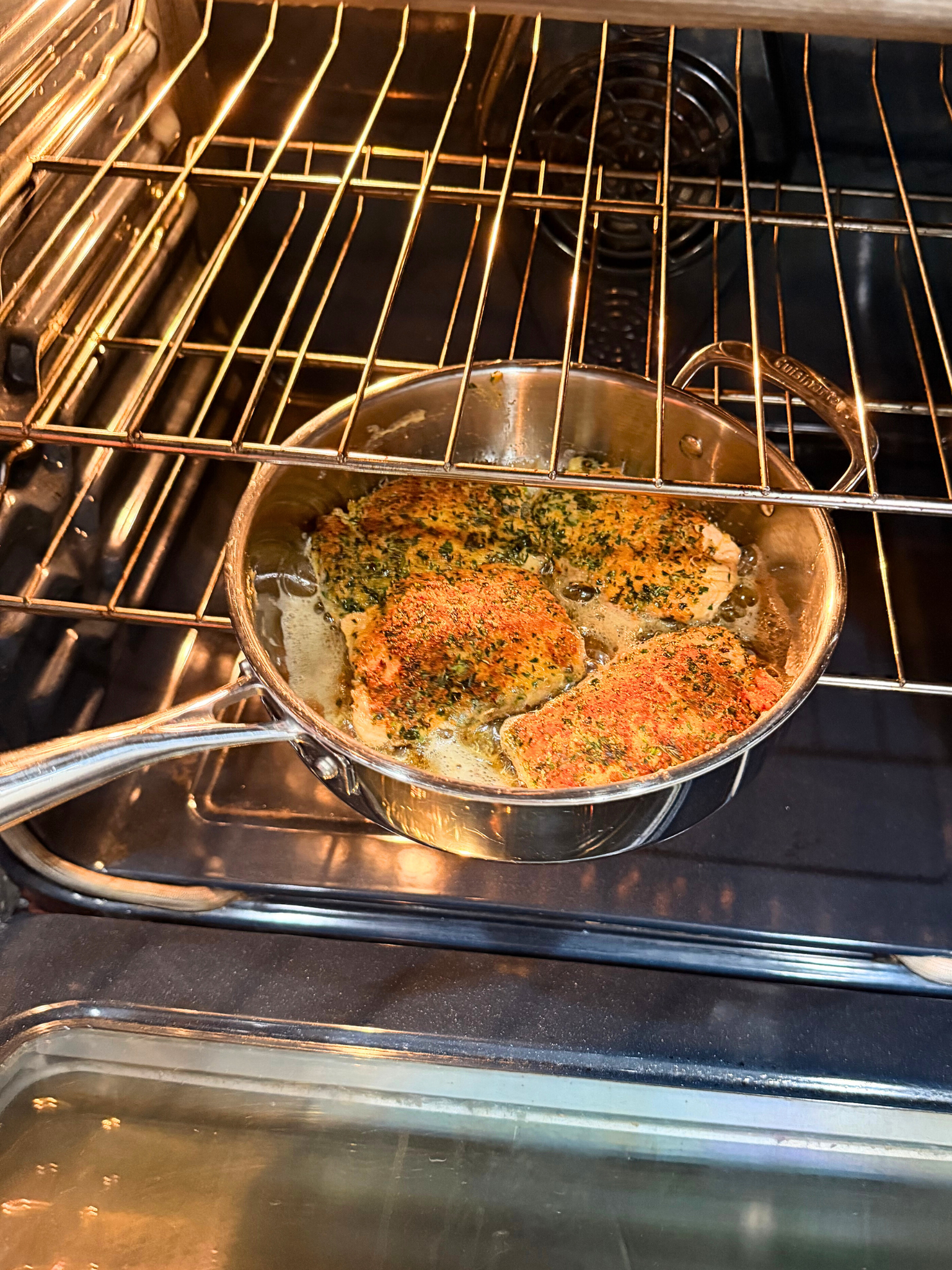 Placing herb crusted salmon in the oven.