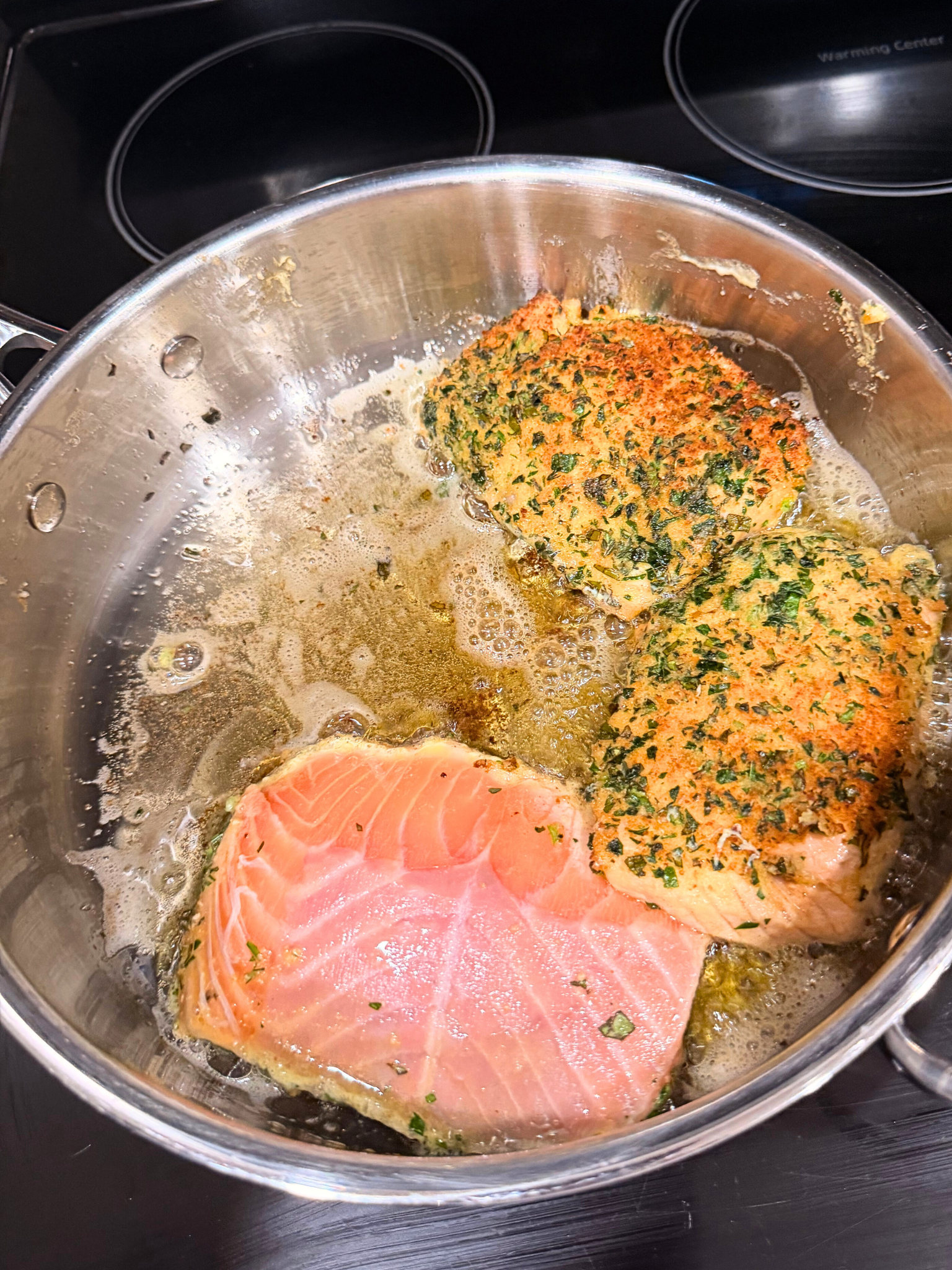 Salmon searing in a pot over the stove.